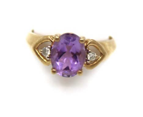 9ct Gold Amethyst and Diamond Ring The Oval Brilliant Amethyst is approx. 9mm x 7mm and the two side Round Brilliant Cut Diam