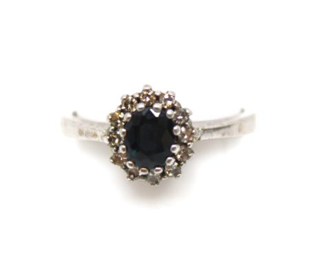 18ct White Gold Sapphire and Diamond Ring The ring contains an Oval Brilliant Cut Sapphire that measures approx. 5.73mm x 4.2