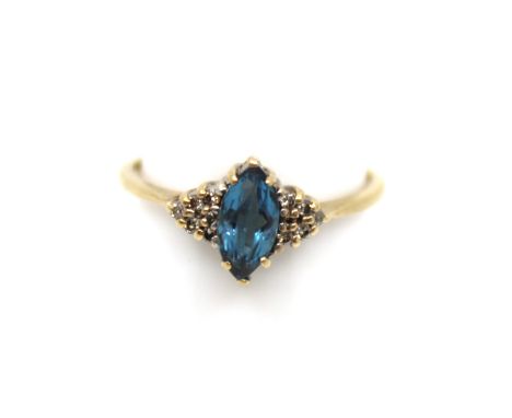 9ct Gold Topaz and Diamond Dress Ring The Marquise shaped Topaz measures approx. 8mm x 4mm.  The ring contains six surroundin