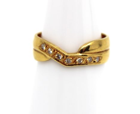18ct Yellow Gold Diamond Ring/Wedding Band? The ring contains seven melee Round Brilliant Cut Diamonds.  The ring is hallmark