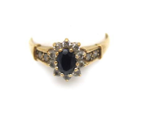 9ct Yellow Gold Sapphire and Cubic Zirconia Dress Ring  The ring contains an Oval Brilliant Cut Sapphire that measures approx