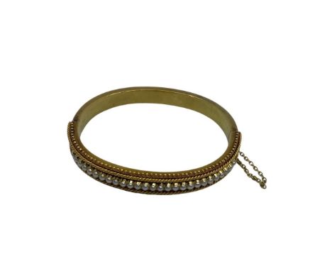 15ct Yellow Gold Pearl Half Hinged Bangle with Safety Chain.  The Bangle contains Twenty-seven Seed Pearls on the front of th