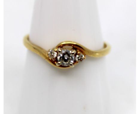 18ct Yellow Gold Three Stone Trilogy Diamond Ring  The ring contains an approx. 0.15ct Round Brilliant Cut Diamond in the cen