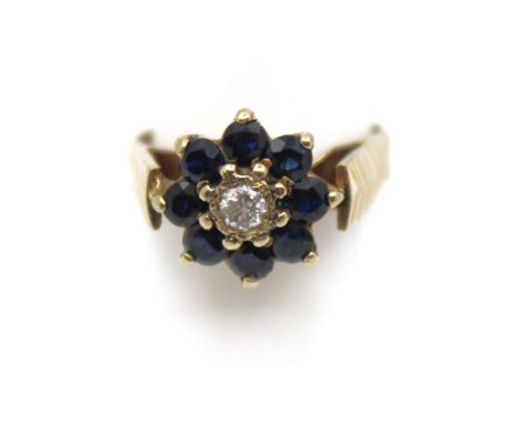 18ct Yellow Gold Sapphire and Diamond Cluster Ring  The ring contains eight Round Brilliant Cut Sapphires that measure approx
