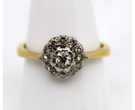 18ct Yellow Gold Diamond Cluster Illusion Set Ring  The ring contains a Solitaire Round Brilliant Cut Diamond in the centre t