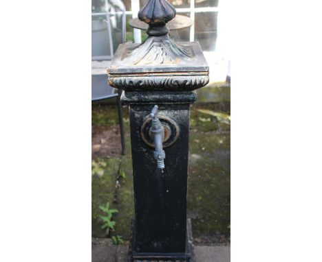 A cast iron village pump style garden tap column on a small trough base. Approximately 120cm high.