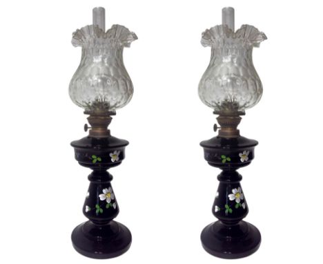 Pair of lamps in black opal, XX century. Frame gilt metal, white glass bowls. H 53 cm, 15 cm base.