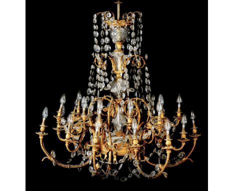 A substantial gilt metal and cut glass hung twenty four-light chandelier, late 19th century, with twelve scrolling foliate ca