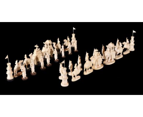 ϒA fine Indian carved ivory John Company chess set, circa 1825, possibly Berhampur, the blacks and the whites differentiated 