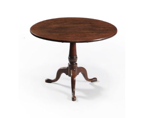 A George III mahogany tripod supper table, circa 1780, the single plank top above a turned pillar with acanthus vase and thre