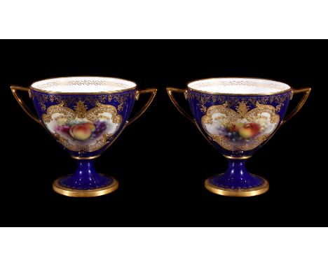 A pair of Royal Worcester blue-ground and gilt two-handled cabinet cups signed and painted by George Cole, 1910, decorated wi