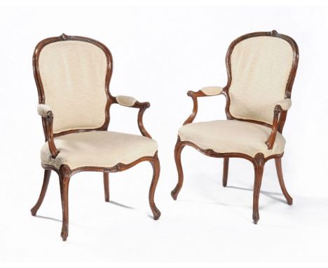 A pair of George III mahogany elbow chairs, circa 1770, possibly by John Linnell, each cartouche shaped and moulded back surm