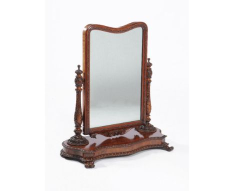 An Anglo-Indian padouk dressing mirror, mid-19th century, of large proportions, the shaped mirror plate on heavily acanthus c