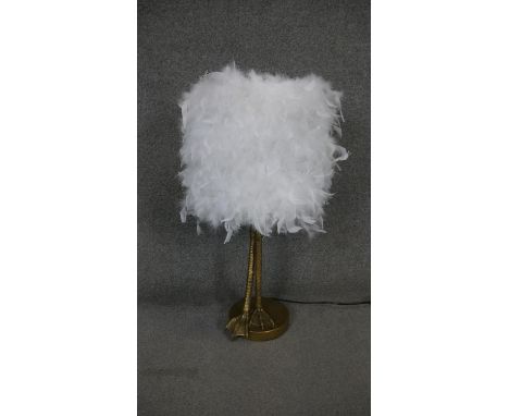 A desk lamp with white feather shade and gilt resin bird leg stem. H.78cm 