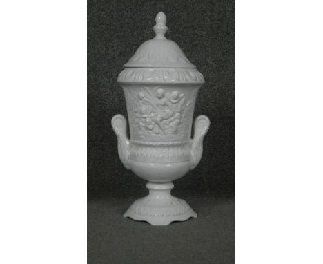 A Pereiras ceramic Portuguese white glazed Classical design two handled lidded urn. Makers stamp to the base. 
