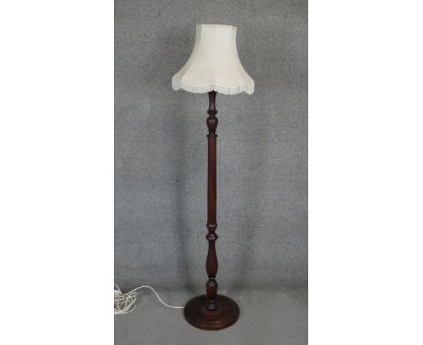 A mahogany standard lamp with turned column on platform base. H.168cm 