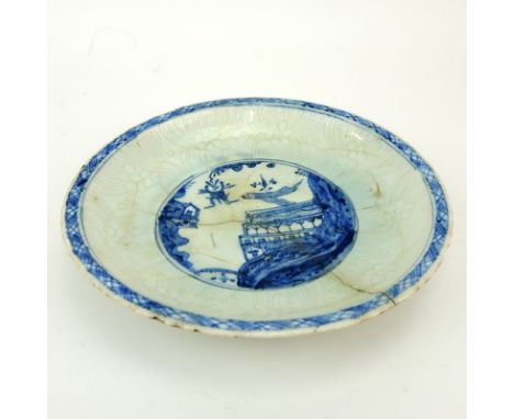 17th Century Persian Blue and White Glazed Ceramic Shallow Bowl. Depicts a palace view near mountains, floral motif, raised e