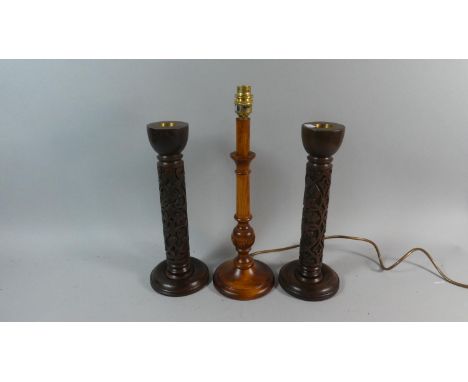 A Pair of Modern Blind Carved Wooden Candle Sticks and a Wooden Table Lamp 