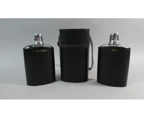 A Leather Cased Two Bottle Flask Decanter Set for Whisky and Gin, 18cms High 