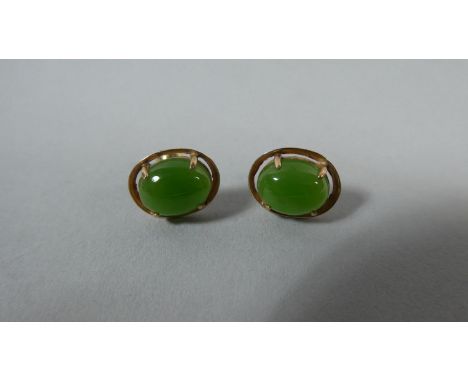 A Pair of Jade and Yellow Metal Stud Earrings Stamped 14K 