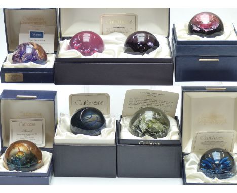 Eight Caithness limited edition glass paperweights including a Dawn and Dusk set, Blue Spiral, Magic Roundabout etc, one with