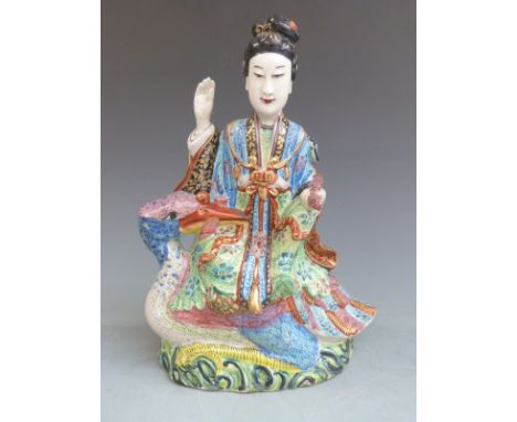 19th/20thC Chinese polychrome figurine astride a bird holding a scroll in its beak, height 27cm