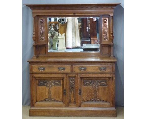Art Nouveau oak sideboard with bevelled mirror back flanked by embossed hammered copper panels, the base fitted two drawers a