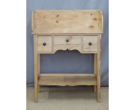 A small pine wash stand with three drawers, under shelf and gallery back, W76 x D38 x H100cm