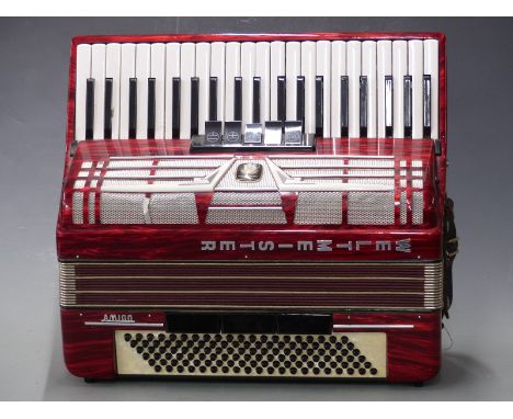 Weltmeister Amigo 120 bass piano accordion with 5 treble and 3 bass couplers in red pearloid finish, with hard carry case