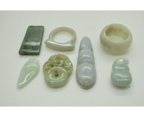 A small collection of jade items comprising two rings and four pendants