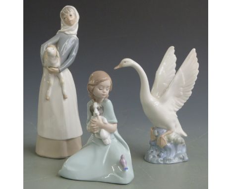 Lladro figurine girl with lamb and two Nao figures, tallest 27cm