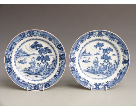 Near pair of 19thC Chinese export plates decorated with a figure on the shore with fishing boats, diameter 23cm