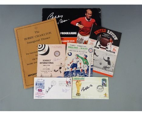 A collection of mainly Manchester United related memorabilia comprising Bobby Charlton signed The Bobby Charlton Inaugural Di