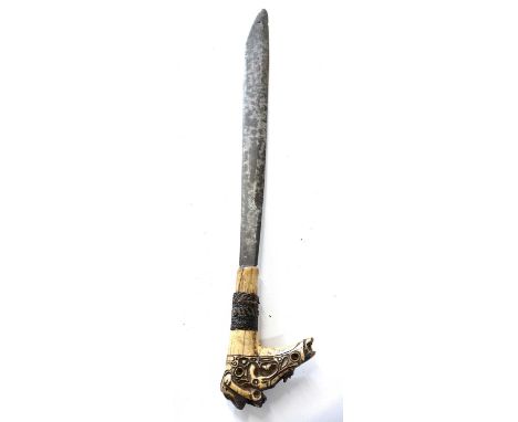 Indonesian Mandu headhunters sword originating from Southern Borneo and wooden scabbard, bone carved decorated handle with re