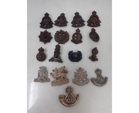 Seventeen plastic British Army Cap Badges including Royal Army Ordnance Corps, Royal Corps of Signals, The Essex Regiment, et