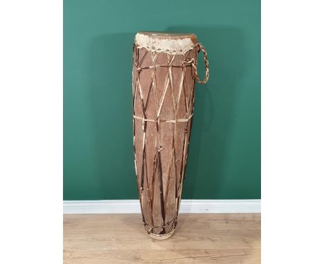 A West African dug out trunk and skin covered Talking Drum 4ft 1in H 