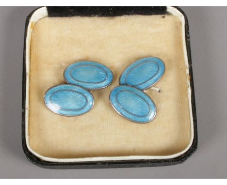 A pair of silver cufflinks with blue enamel decoration.  Minor scratches to enamel.