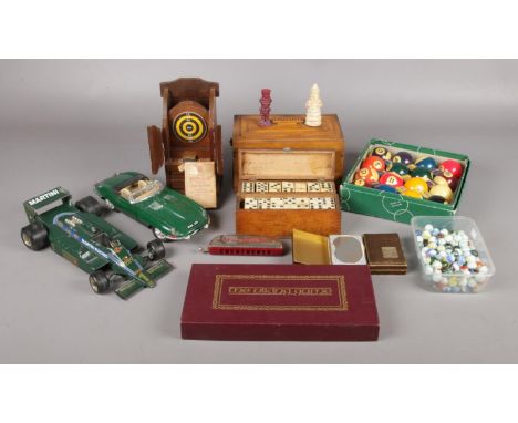 A collection of games. To include Aramith pool balls, dominoes, cards and scale model of cars  