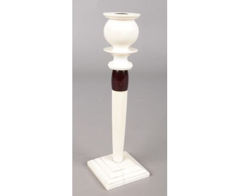 An ivory candlestick with bakelite collar, circa 1920s. 20cm.  Scorch to candle holder. Split to base.