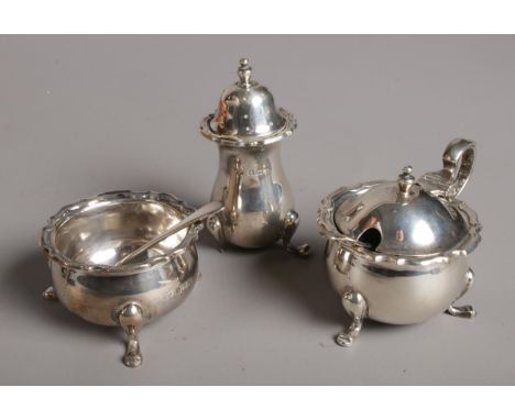 A 1920s three piece silver cruet set by Mappin &amp; Webb Ltd.  Pepperette missing one foot.