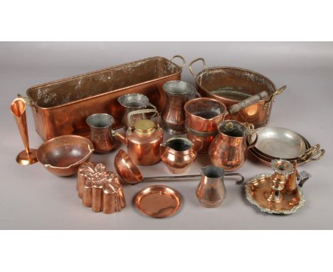 A good collection of metalwares. Includes antique copper measures and jugs, chamber stick, mould etc.  Small dents to side of