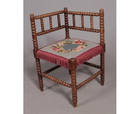 A mahogany bobbin turned corner arm chair.  