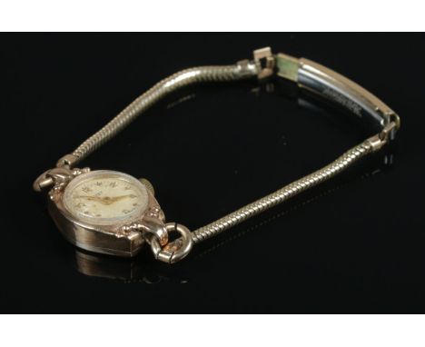 A ladies Rotary cocktail watch, with 9ct Gold face and back, on rolled gold strap. In working order.  