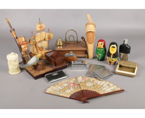 A box of assorted collectables. To include goblin nutcracker, novelty bird cigarette dispenser and russian dolls.  