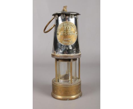 An Eccles CR6S miners safety lamp, made by the Protector Lamp &amp; Lighting Company Ltd. H: 24.5cm.  Dents to the top.