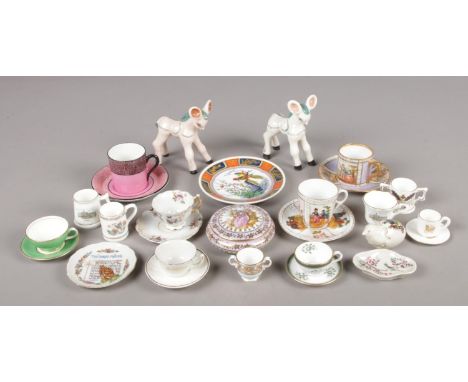 A collection of ceramics, mainly miniatures. Includes Basil Matthews, cups and saucers, crested ware etc.  