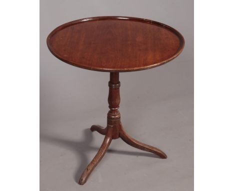 A Georgian mahogany circular tilt -top tripod table. H:60.5cm, W: 58.5cm.  Repair to the top edges. Damage to the underneath.