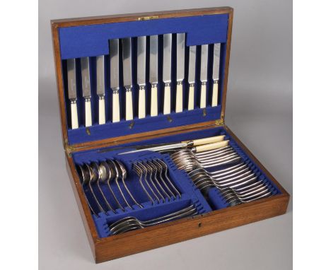 An oak canteen of Harrison Bros &amp; Howson silver plated cutlery.  