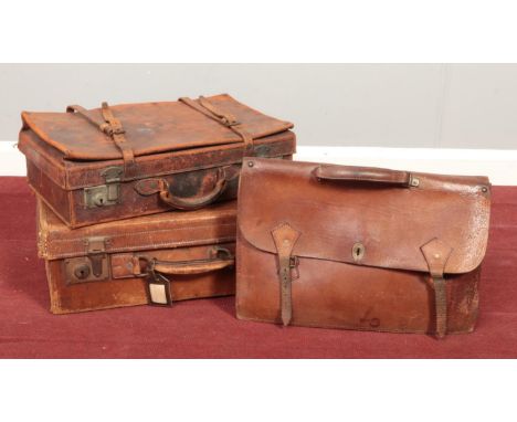 Two vintage leather suitcases along with a leather satchel.  