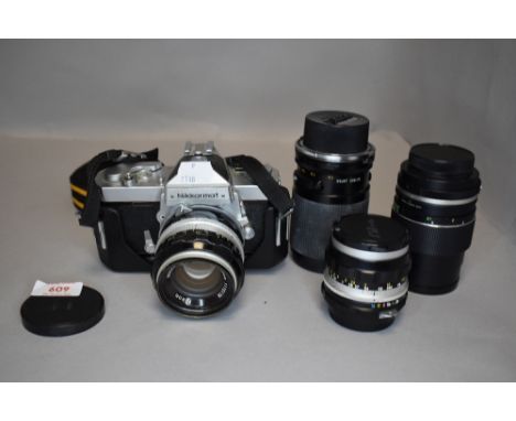 A Nikon Nikkormat N camera body with a Hansa 135mm lens, a Nikkor 35mm and 50mm lenses and a Tamron 135mm lens in a leather c